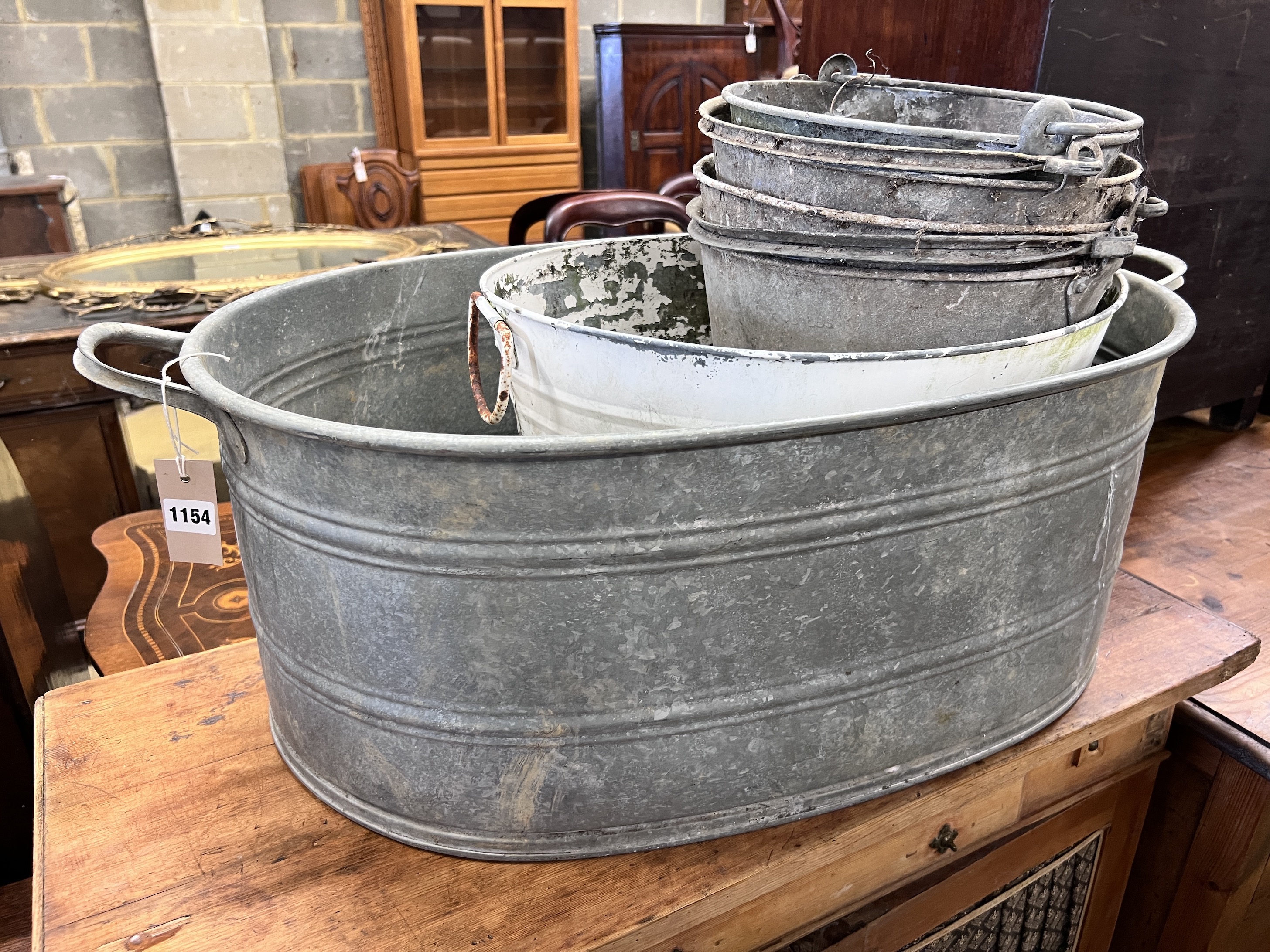 A Victorian galvanised metal wash tub, a white painted pail tub and four assorted buckets, largest 86cm